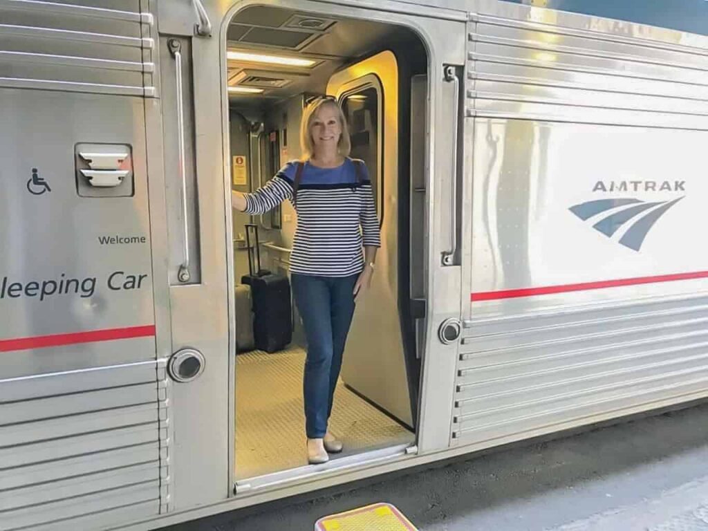 Aboard Amtrak train, Sherry standing in doorway.